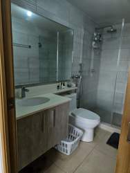 Living dining area with large windows overlooking greenery, porcelain floors, roller blinds