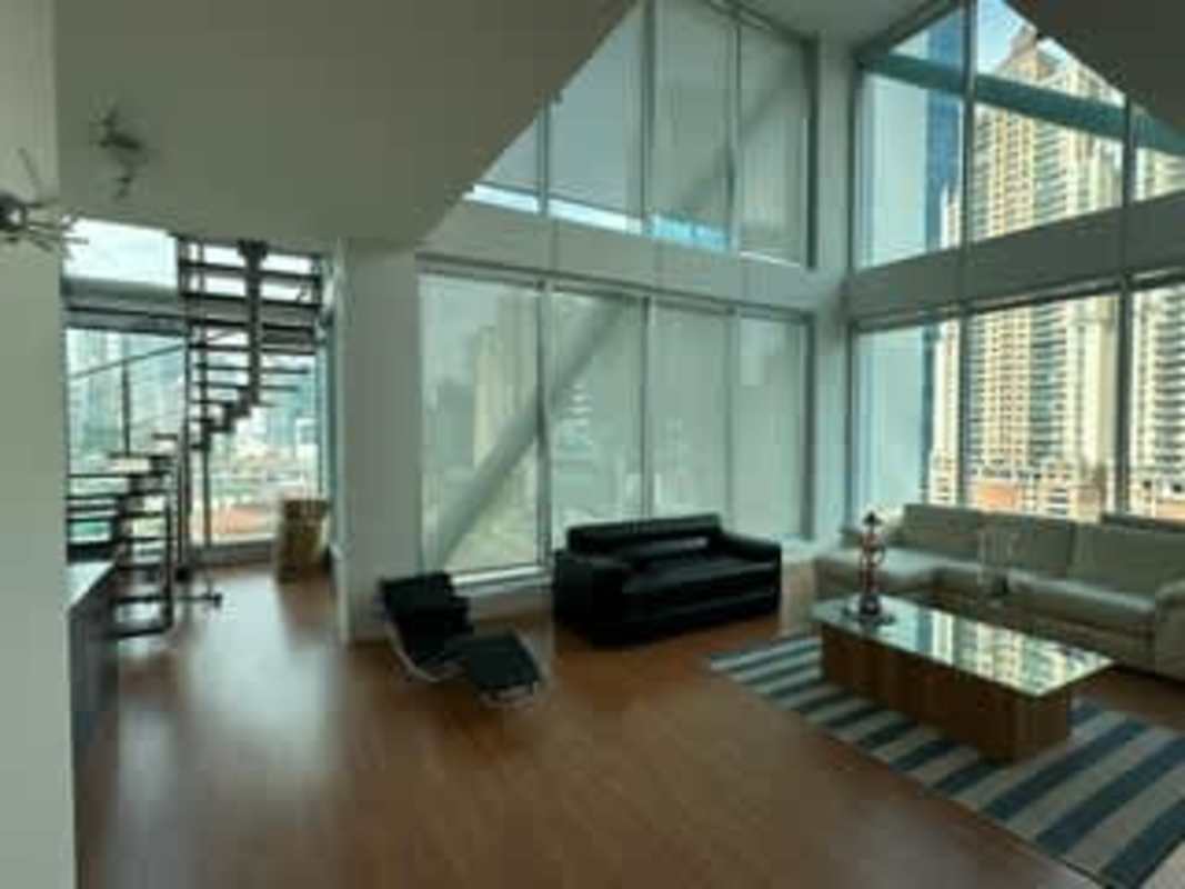 Modern loft bedroom with floor-to-ceiling windows offering skyline views Panama