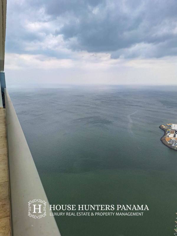 Bathroom with marble vanity large mirror modern fixtures The Ocean Club Punta Pacifica Panama