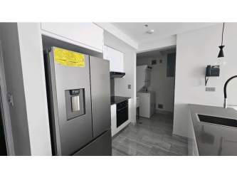 Spacious living area with floor-to-ceiling windows featuring ocean and skyline view in PH Nuovo Armani Bella Vista Panama