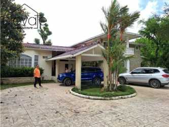 Exterior view with carport, balcony, lush garden, traditional design in El Valle Residence Panama