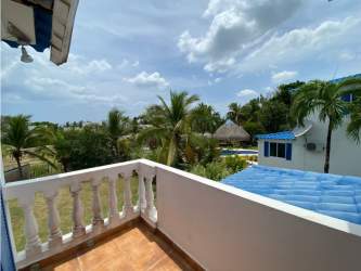 Covered terrace with Mediterranean arches, fan, outdoor seating at Playa Blanca Resort Panama