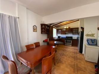 Bedroom with two beds, wood beams, AC, ceiling fan in Playa Blanca beach villa Panama