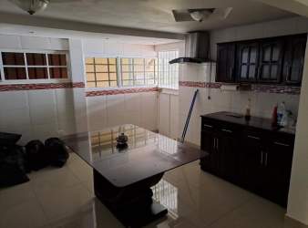 Kitchen with tiled walls, cabinets, dining area Hato Montaña Arraiján