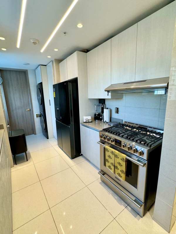 Luxurious bathroom with large mirror, vessel sink, and glass shower in PH Costanera Panama