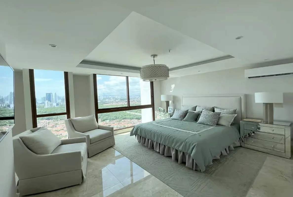 Private balcony with glass railings overlooking city skyline and golf course Panama