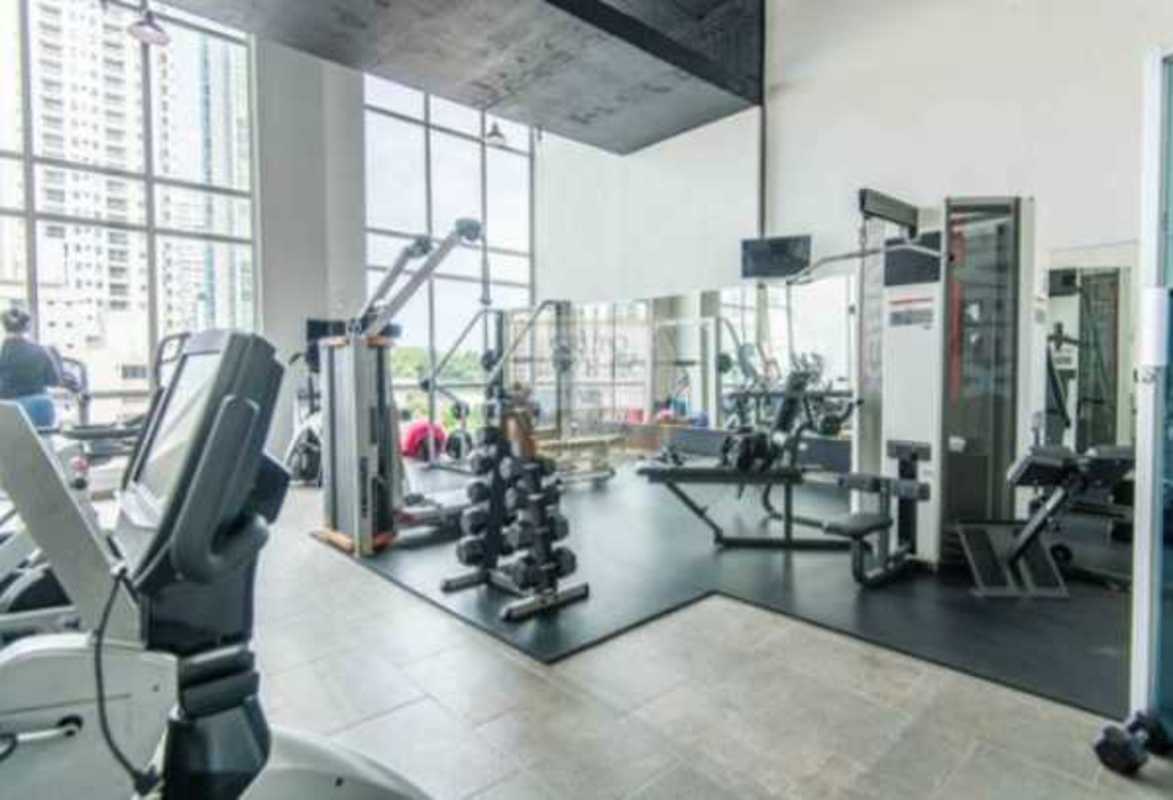 Modern gym with equipment and city views in PH Quartier 74 San Francisco Panama