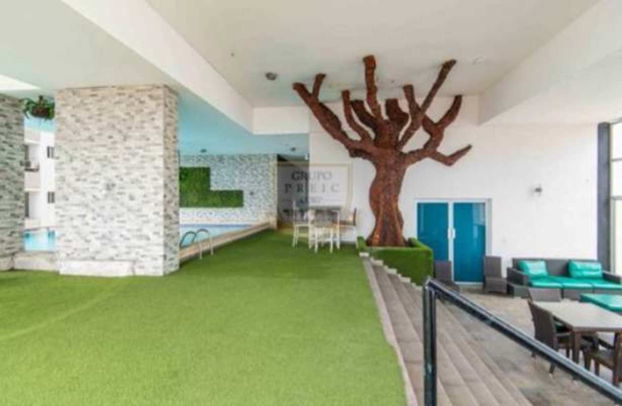 Indoor social lounge and swimming pool area with garden wall in PH Quartier 74 Panama City