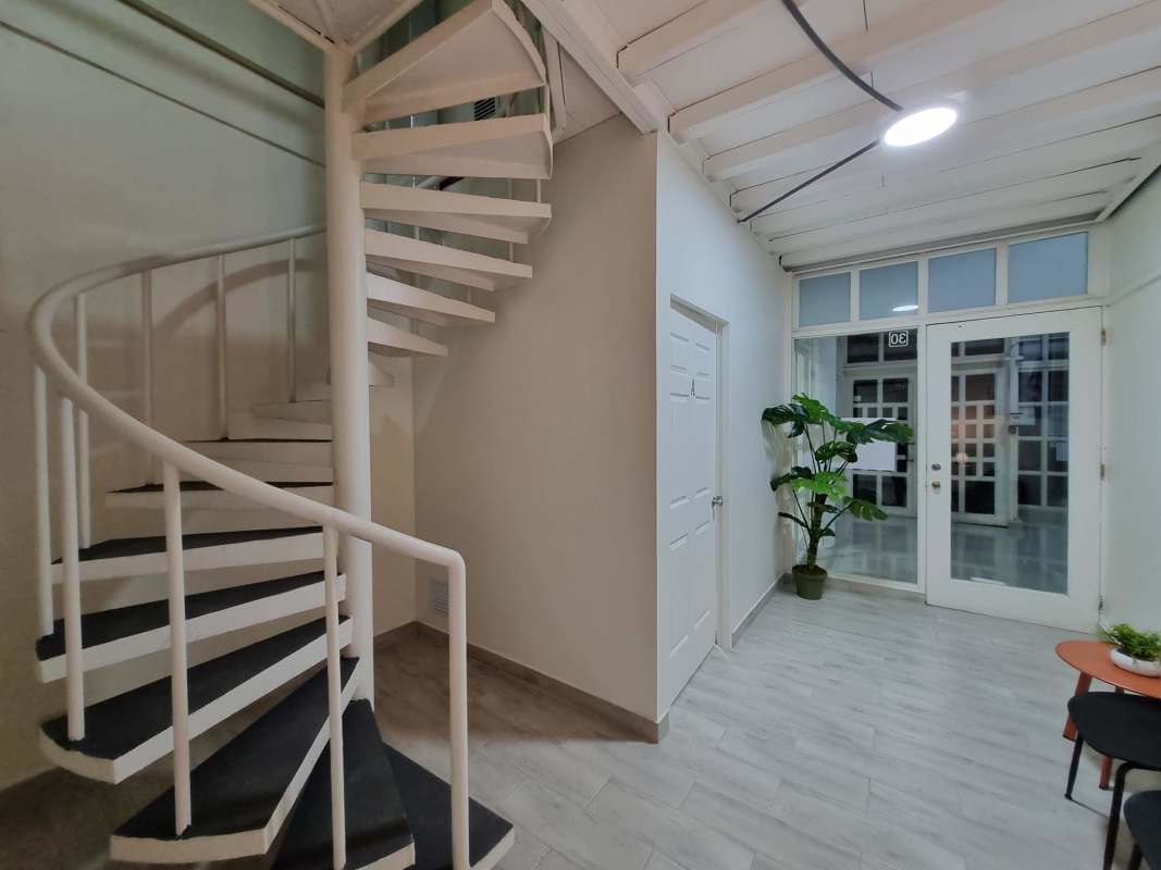 Modern minimalist reception area with chairs and abstract art at Plaza Paitilla Panama