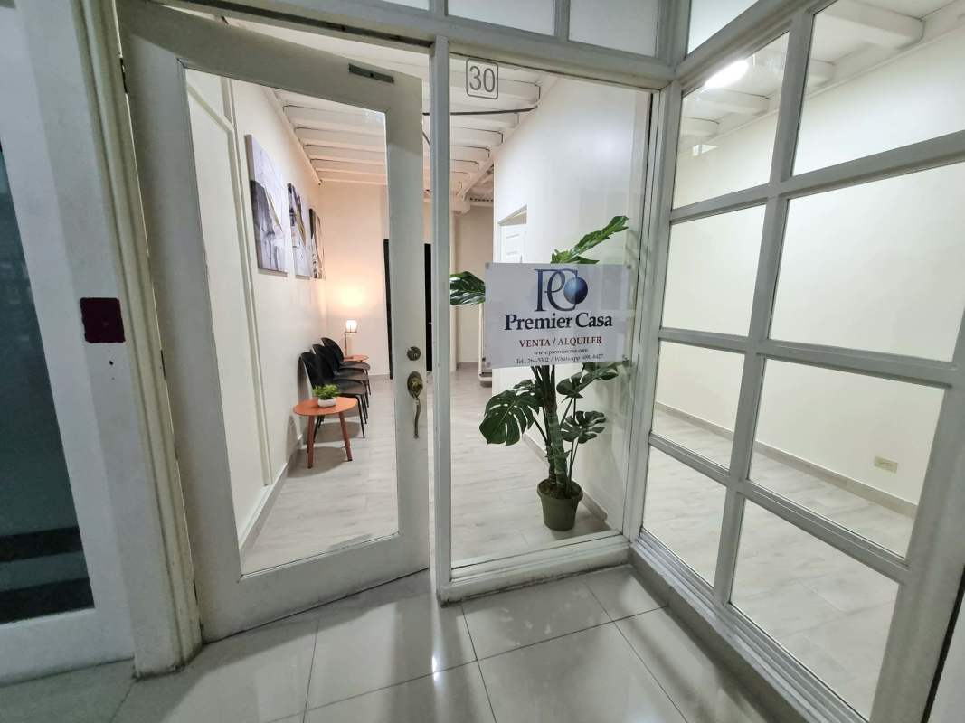 Glass entry door and reception chairs commercial tower Plaza Paitilla Panama