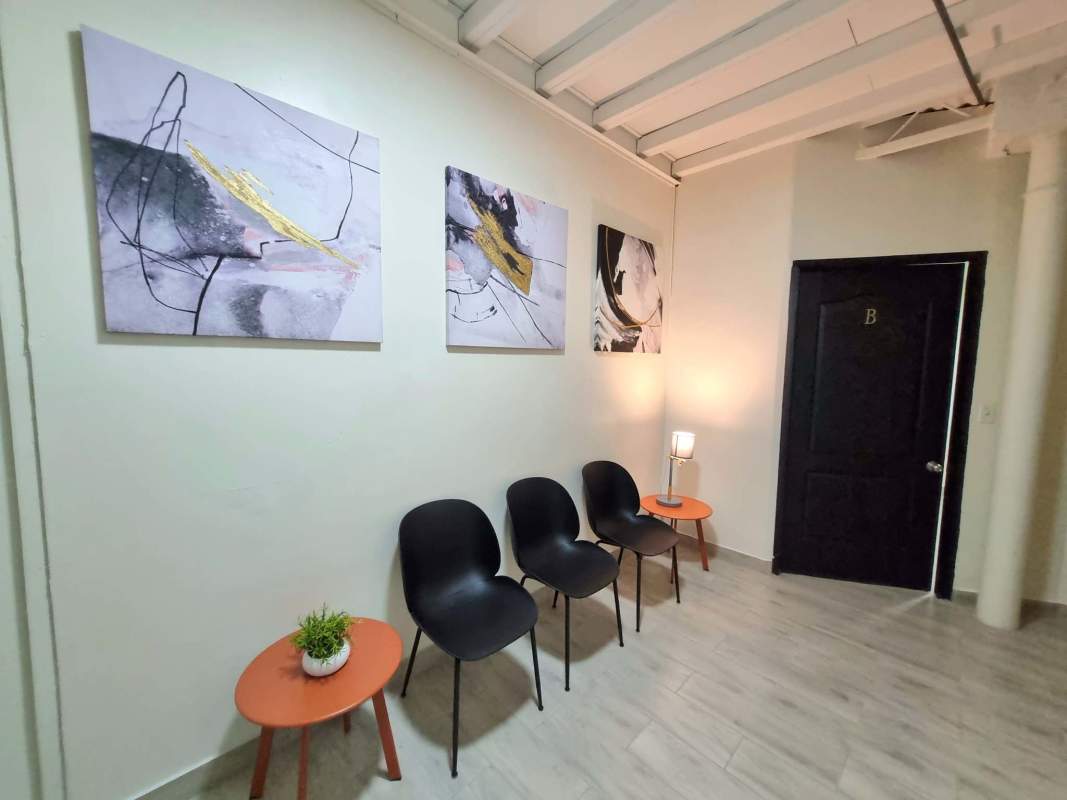 Reception area with glass doors black office chairs Plaza Paitilla Panama City