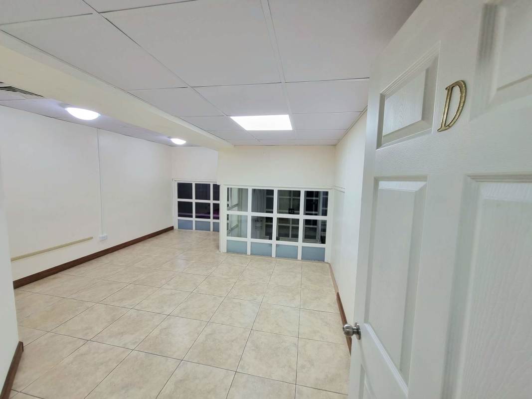 Office hallway with spiral staircase glass doors Plaza Paitilla Panama