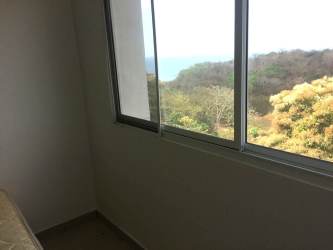 Modern sliding closet dark wood with shelves PH Ocean View Playa Corona beach apartment
