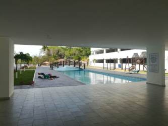 Distant ocean view over forested hills from rooftop PH Ocean View Playa Corona