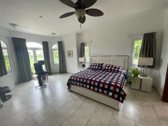 Spacious living area with high ceilings and natural light in Tucán Country Club Panama