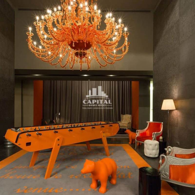 Rooftop infinity pool with skyline view illuminated at night in PH Arts & Yoo Panama