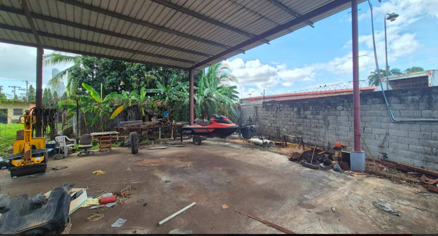 Open industrial lot with gravel yard warehouse and parked vehicles Ciudad Radial Panama