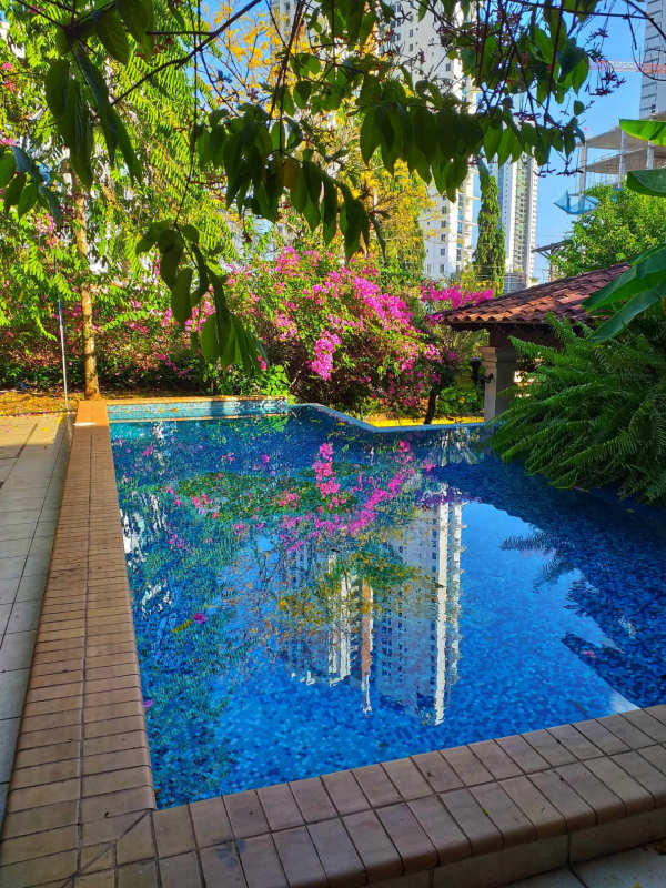 Traditional style large kitchen with wood cabinetry, island and granite counters in mansion Panama City