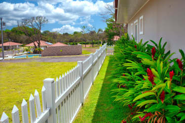 Single family house fenced yard landscaped flower garden Villas del María Bejuco Panama