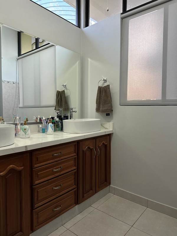 Spacious traditional kitchen with wooden cabinetry and granite countertops in La Alameda home Panama