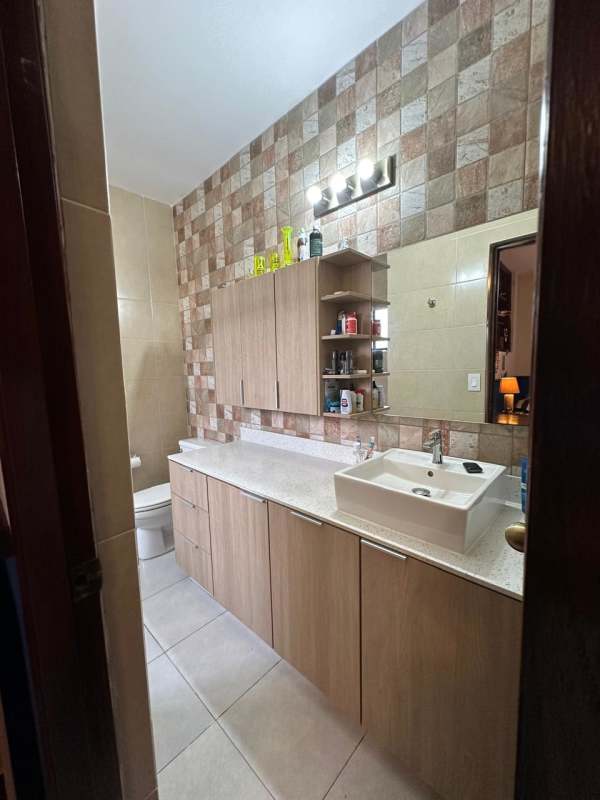 Contemporary bathroom with granite vanity and glass shower in house La Alameda Panama City