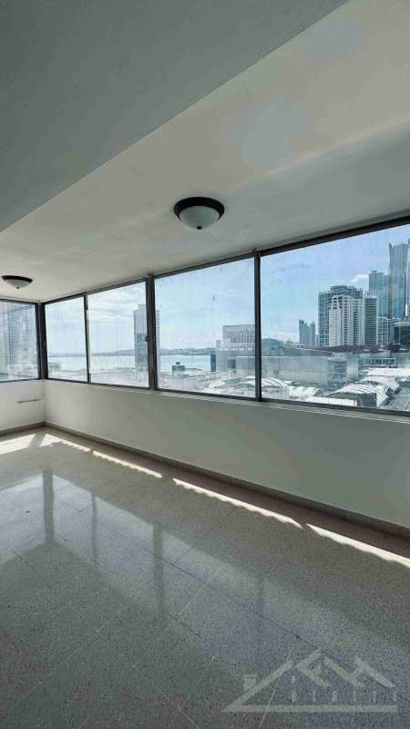 Glass-enclosed balcony sunroom waterfront skyline views PH Paitilla Tower Punta Paitilla