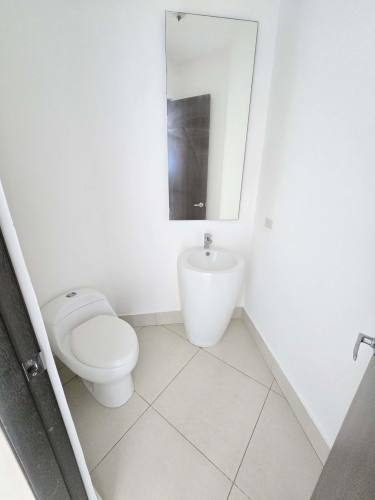 Minimalist half bath with pedestal sink guest toilet at PH Titanium Costa del Este Panama