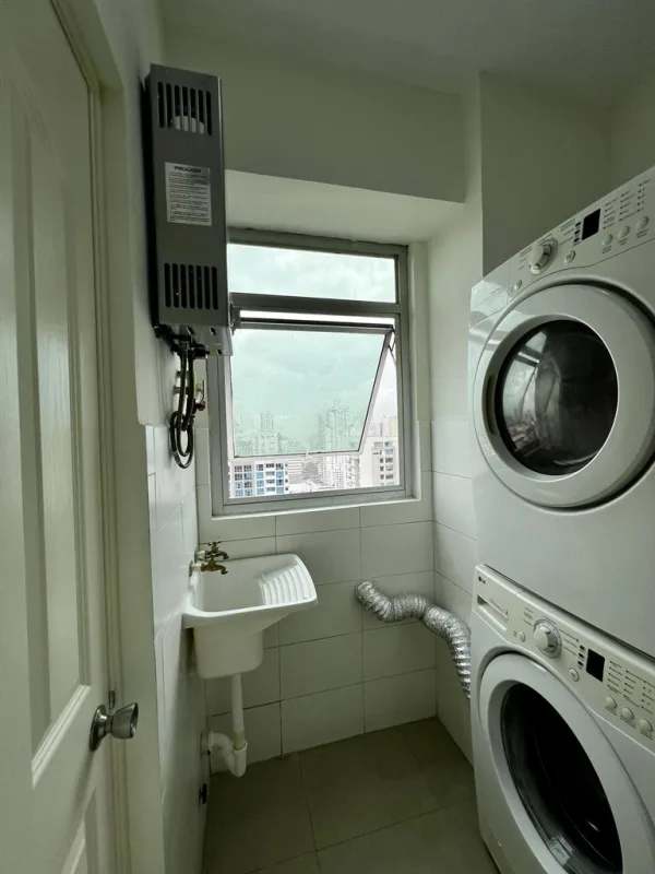 Laundry with stacked washer dryer, utility sink in PH Latorraca Panama City
