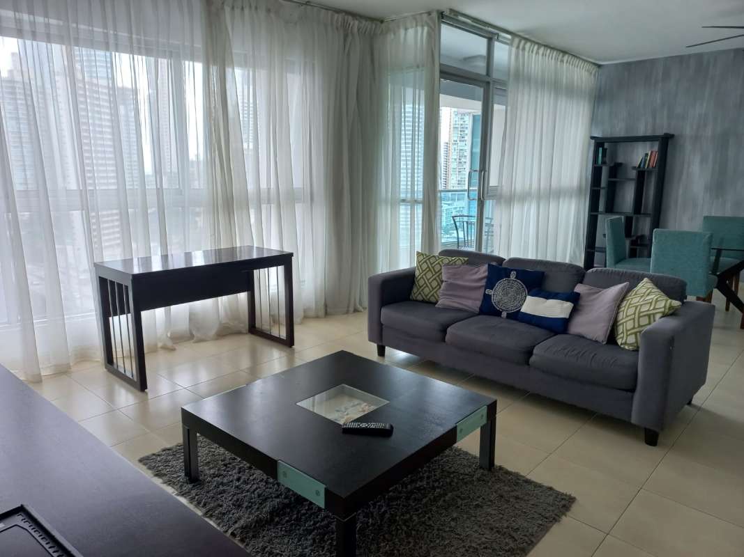 Dining and living room with balcony access in Grand Bay Tower Panama with ocean views