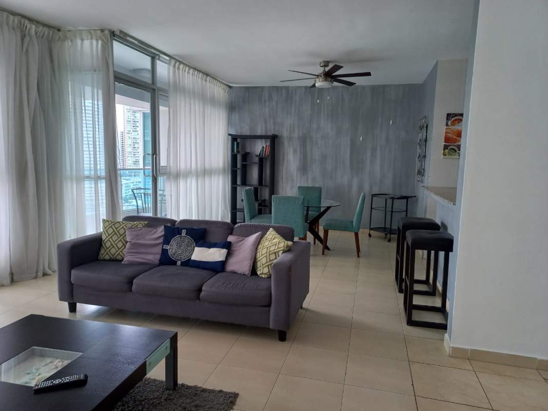 Spacious living room with floor-to-ceiling windows and ocean balcony in Grand Bay Tower Marbella Panama