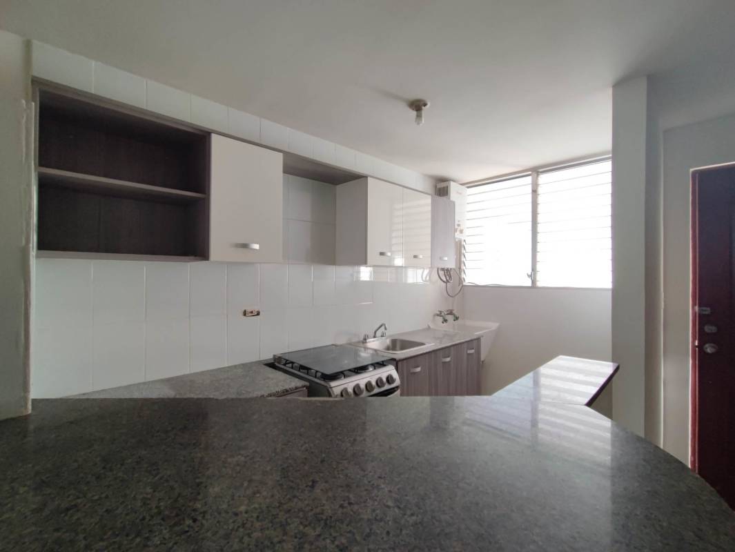 Modern kitchen with breakfast bar open to living area Bella Vista Gardens Panama