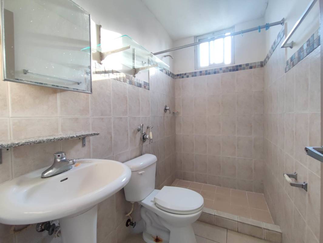 Outdoor pool with lounge chairs city views Bella Vista Gardens Panama