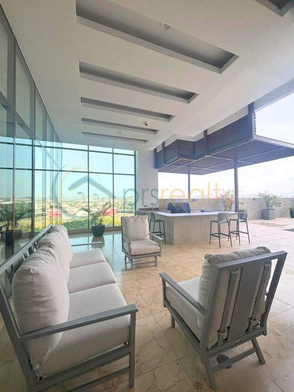 Modern swimming pool with lounge area and skyline views in Santa Maria Golf & Country Club condo Panama