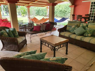 Spacious covered patio with seating area in Coronado Golf Resort house