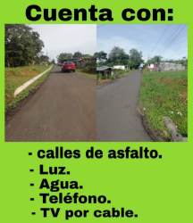 Street and surrounding infrastructure with poles, asphalt access, green space of residential lots in Capira Panama
