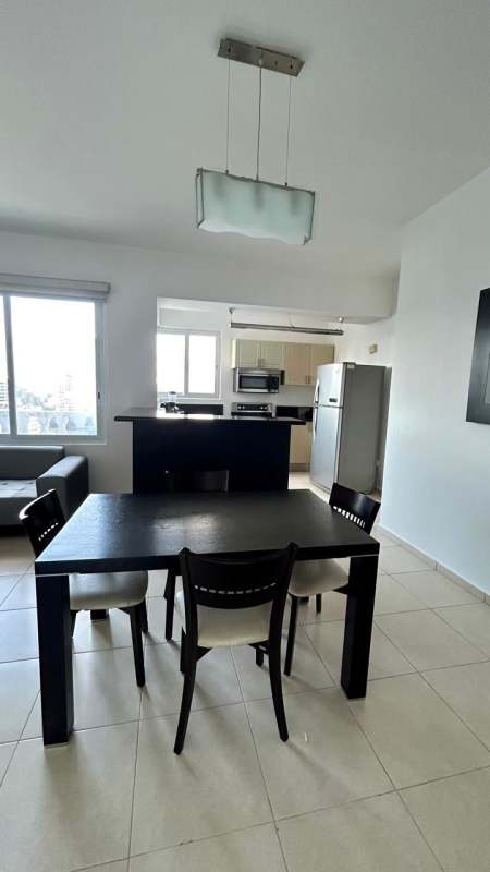 Spacious bedroom with large window, ocean and skyline views at Avenida Balboa Panama
