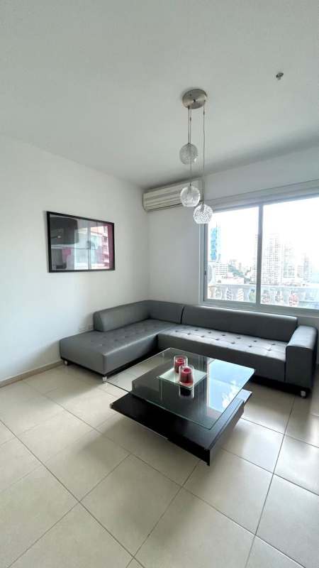 Dining area with large window and open kitchen in PH Vista del Mar Panama City