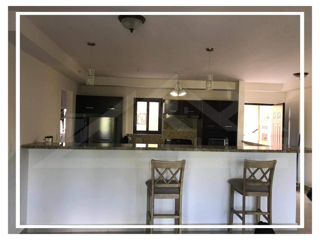 Fully equipped kitchen with granite countertops, breakfast bar and modern appliances in PH Embassy Club Clayton Panama