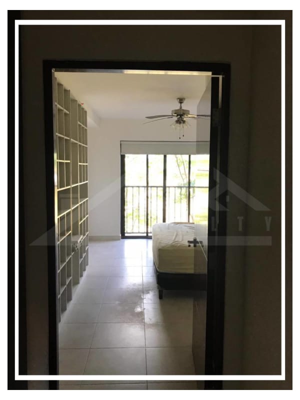 Bedroom with large windows, ceiling fan and built-in shelving Embassy Club Clayton Panama City