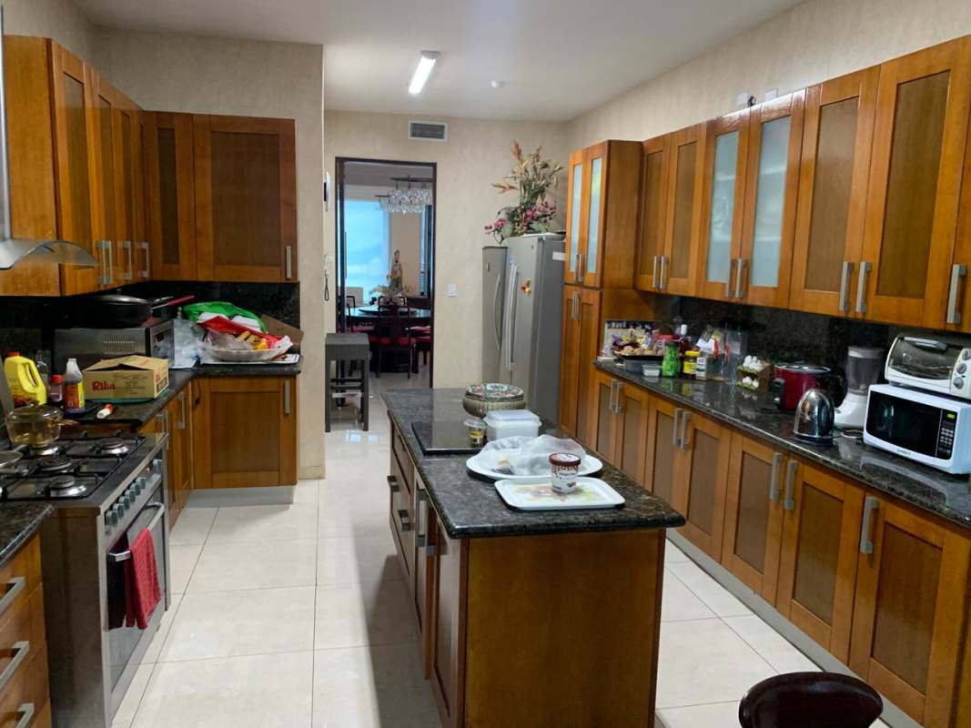 Spacious kitchen with granite islands wood cabinetry appliances in PH Aquamare Punta Pacífica Panama