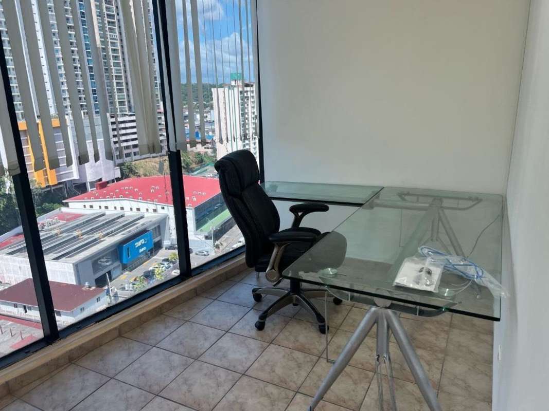 Private office with desk, chair, large window with city view at El Dorado Business Center Panama City
