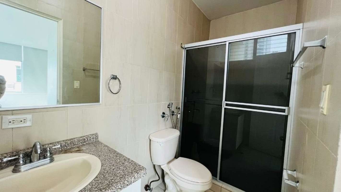 Bathroom featuring granite countertop sink, large mirror and walk-in shower Edison Park Panama