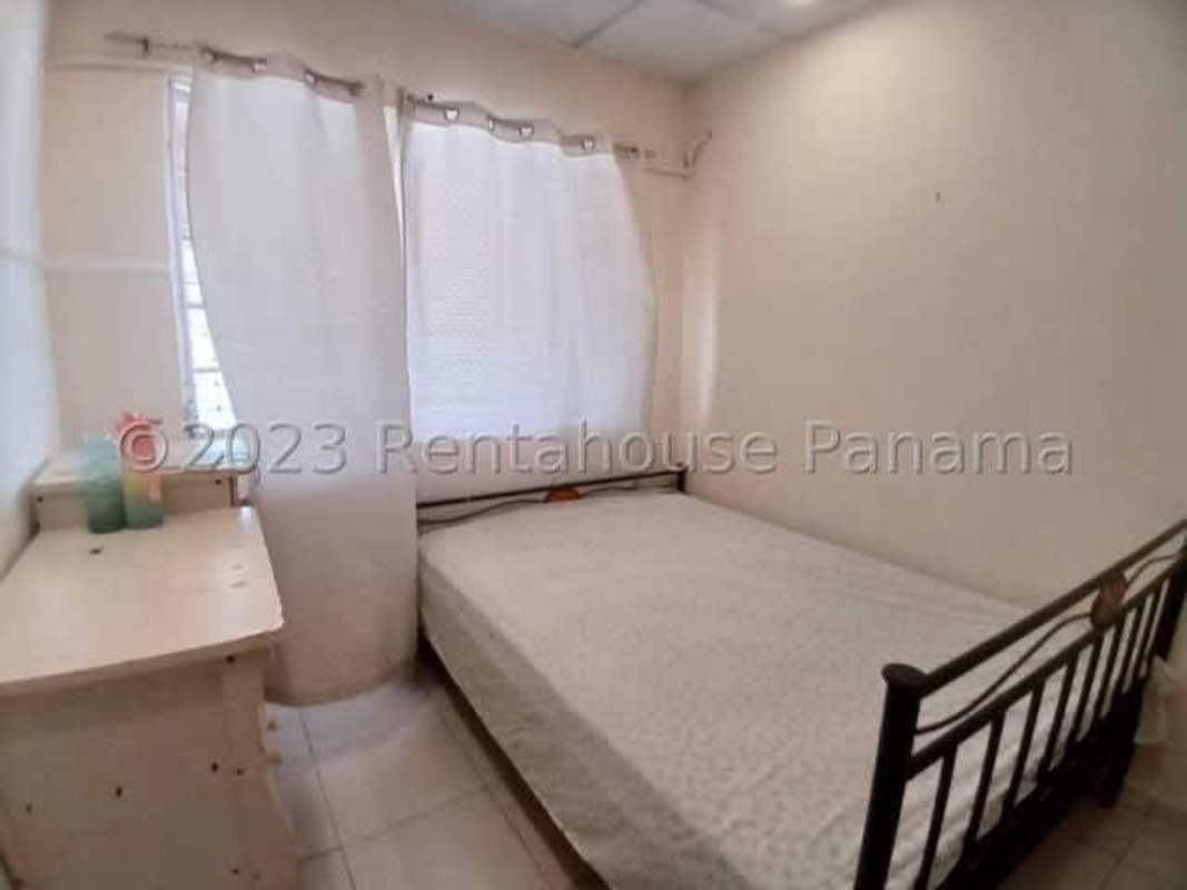 Bedroom with tiled floor, built-in closet, and natural light at remodeled house El Crisol