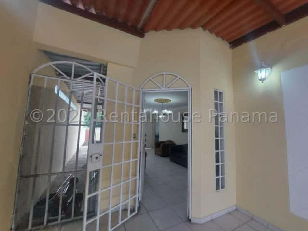 Simple bedroom with tiled floors, AC unit, beige walls for sale in El Crisol Villa Lucre home
