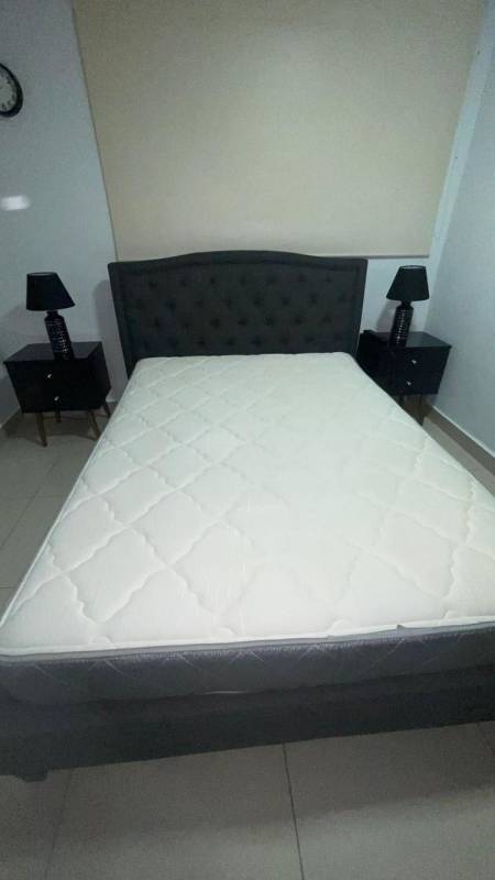 Minimalist bedroom with tufted headboard bed, bedside tables, PH Red Point Panama City