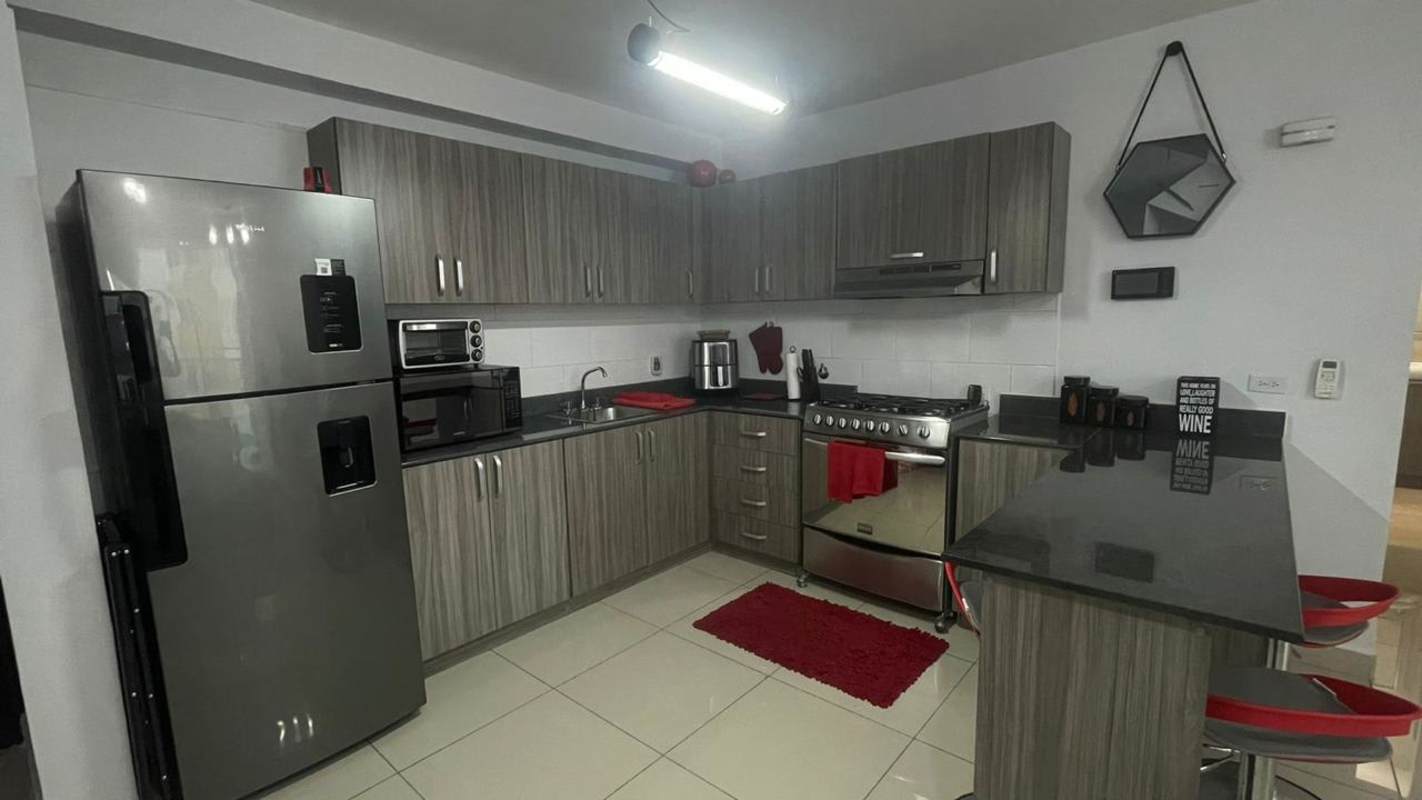 Apartment kitchen with appliances, wood cabinets, granite counters PH Red Point Panama