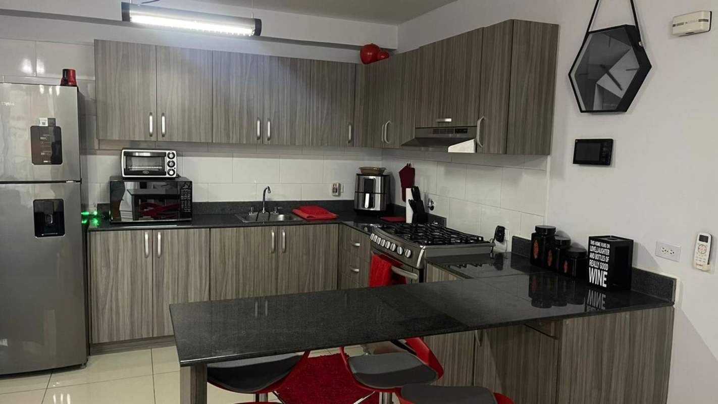 Stylish kitchen with granite countertops, appliances, breakfast bar in PH Red Point San Francisco Panama