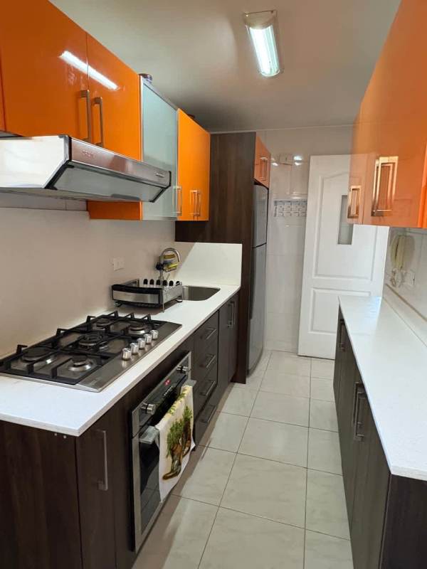 Living and dining room area with tile floors, ceiling fan, large window in PH McGregor Hill Condado del Rey