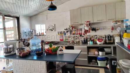 Kitchen area with island, shelves, appliances in La Chorrera Panama