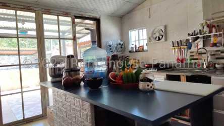 Bathroom with floating vanity sink, wall mirror, tiled walls in La Chorrera home for sale